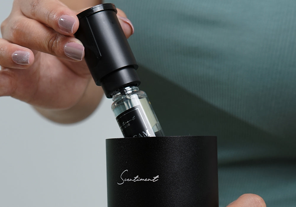 Push the fragrance oil bottle back into the diffuser, making sure to line up the triangle markings at the top of the device.