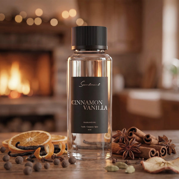 Scentiment Cinnamon Vanilla diffuser fragrance oil with spices and oranges on a wooden surface in front of a fireplace.