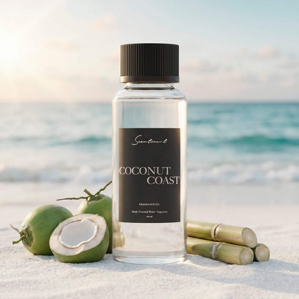 Scentiment Coconut Coast diffuser fragrance oil on a beach with coconuts and bamboo overlooking the ocean.