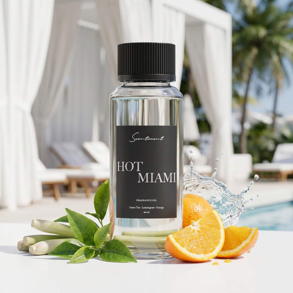 Scentiment Hot Miami diffuser fragrance oil bottle with oranges and leaves on a beach club poolside background.