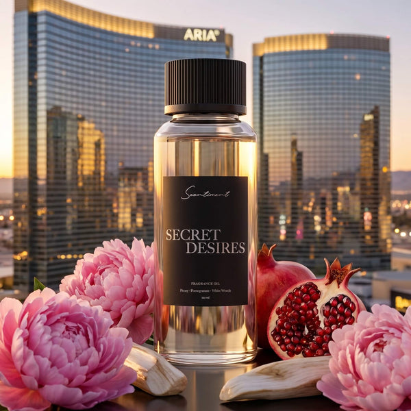 Scentiment Secret Desires diffuser fragrance oil bottle with pink flowers and pomegranates overlooking the ARIA Hotel & Resort in Las Vegas.